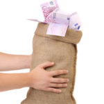Man hands holding money bag full with euro banknotes